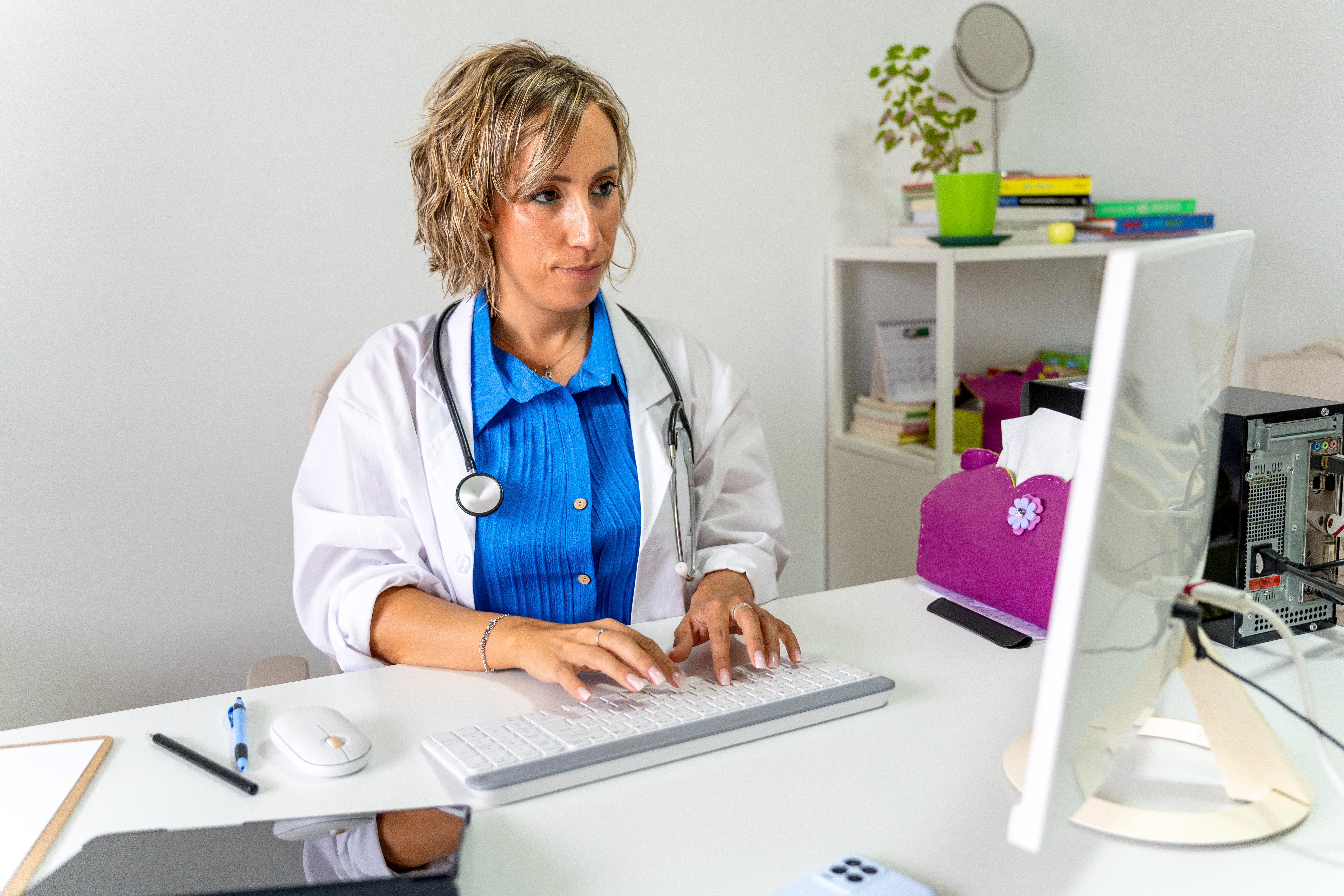 Physician reviewing care information with a colleague in a modern clinic