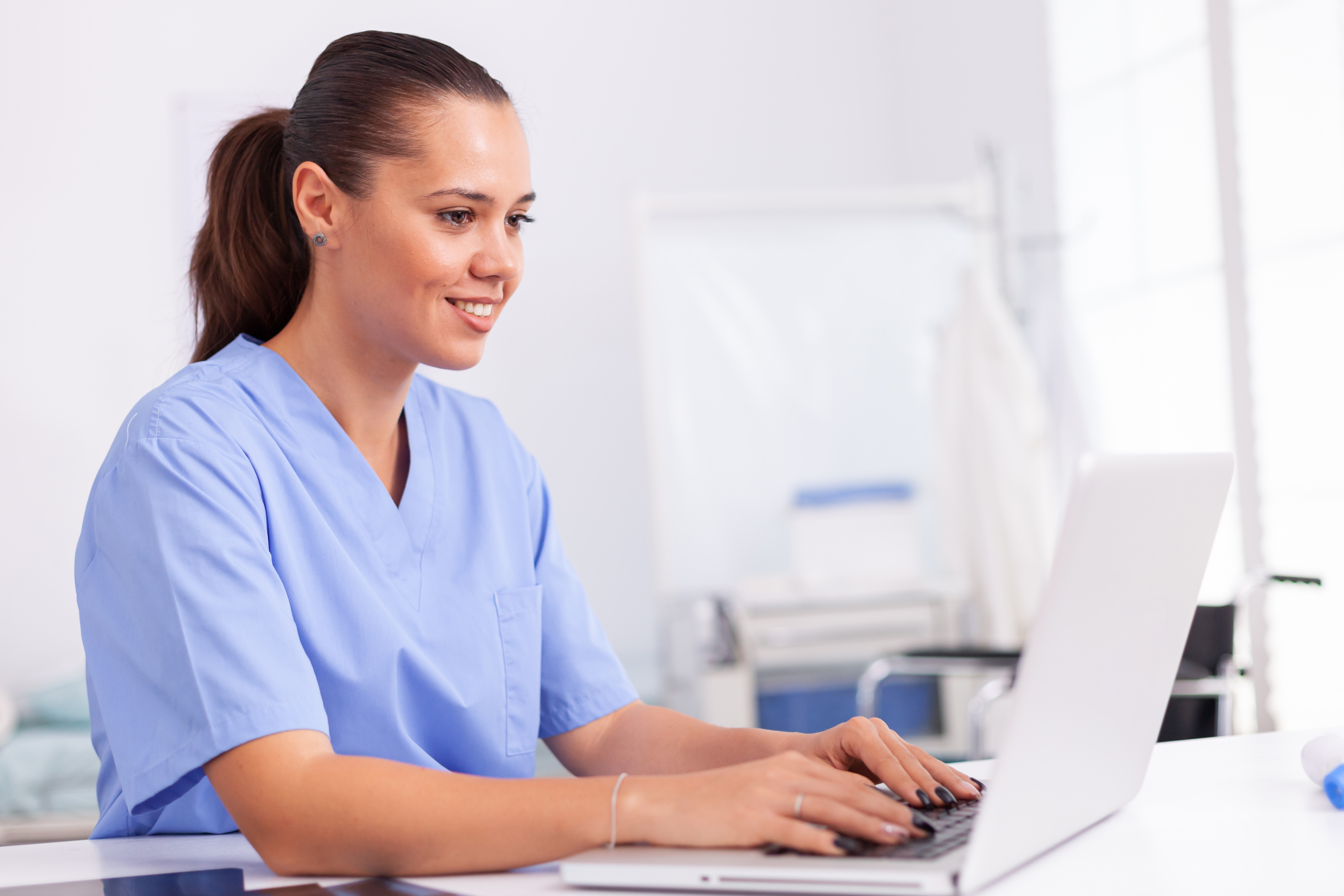 Healthcare administrator managing account follow-up from a clinical office workstation